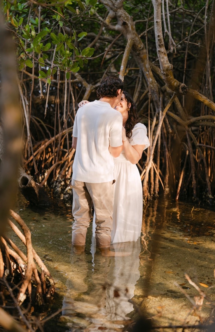 Claudia and Marcus sharing a quiet moment among mangrove roots.